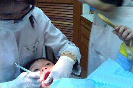 口腔医生给小朋友矫正牙齿,向牙科医生提建议