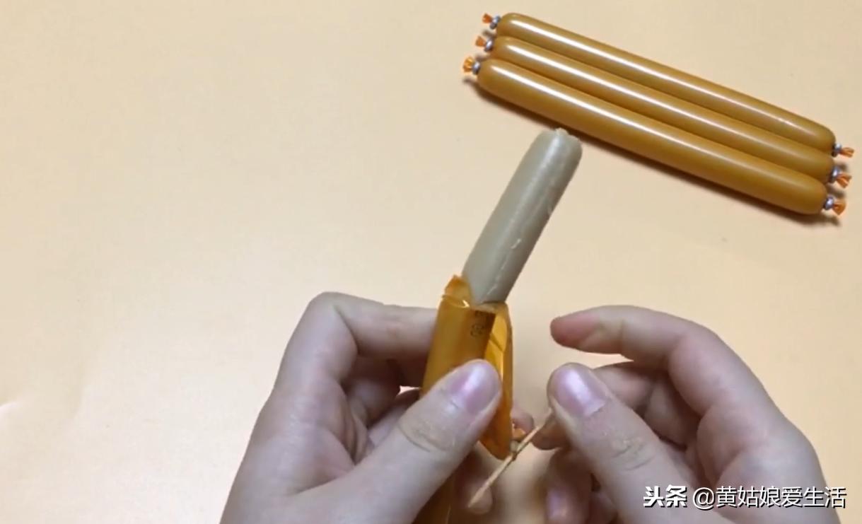 原来火腿肠金属环下有一个小机关,往下一拉完整打开,别再用嘴咬